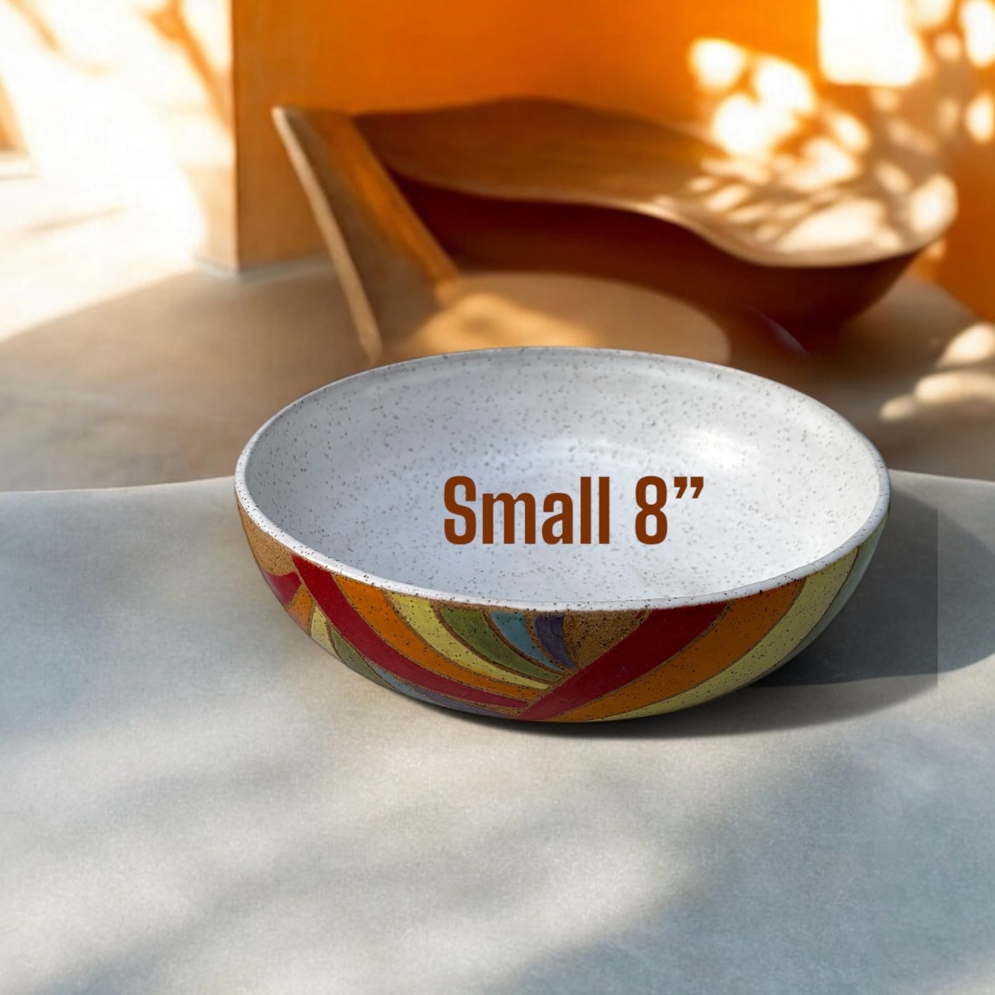 Small ceramic bowl with colorful design and 'Small 8"' text on a light surface.